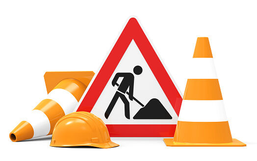 Under construction, road sign, traffic cones and safety helmet, isolated on white background 3D rendering