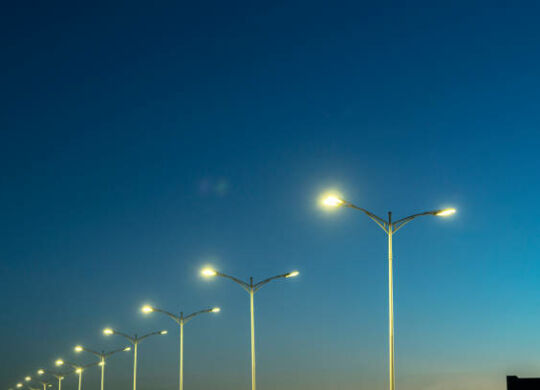 street lamps under blue sky at dusk